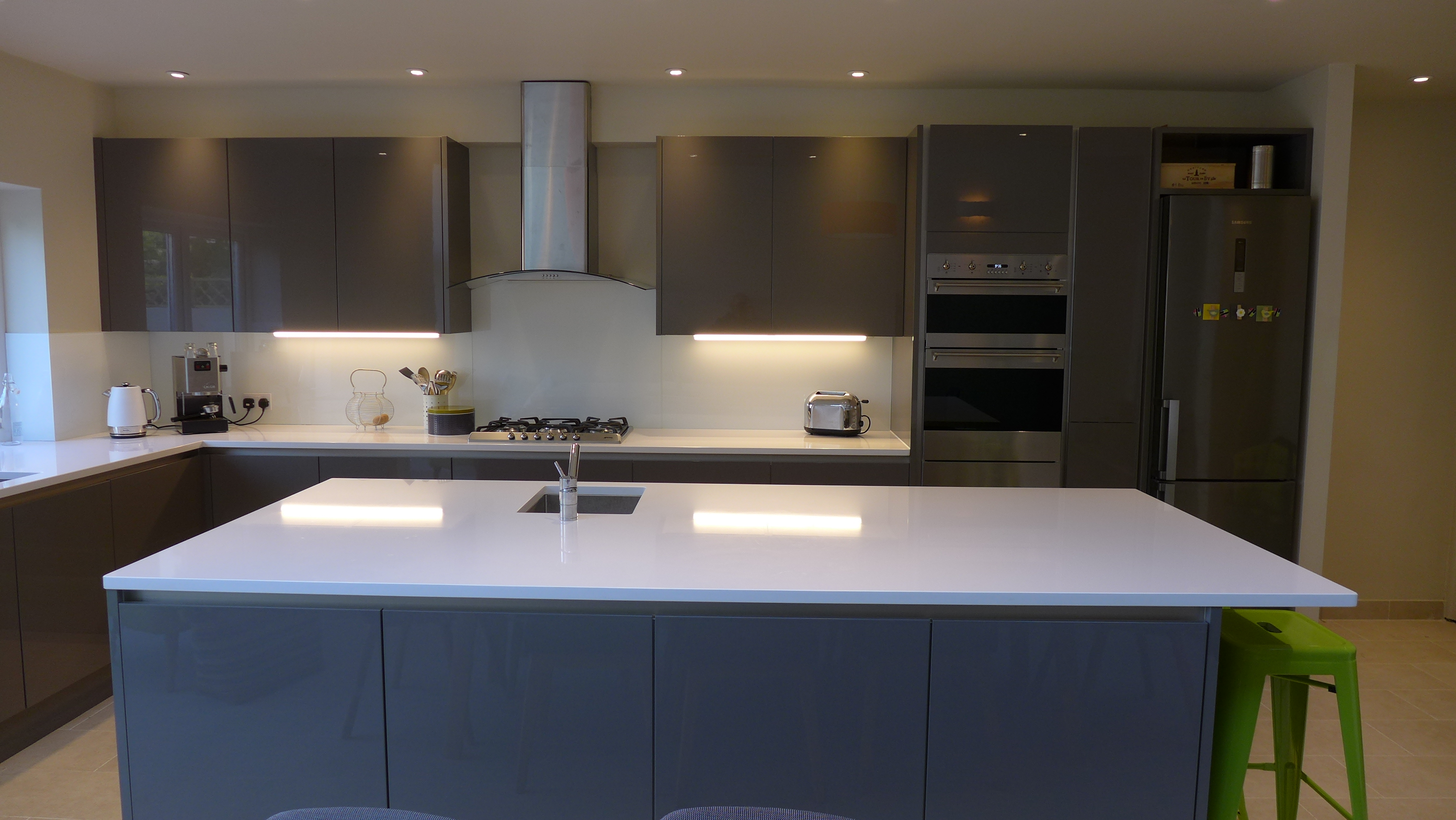 large kitchen island in gloss grey with white quartz worktop