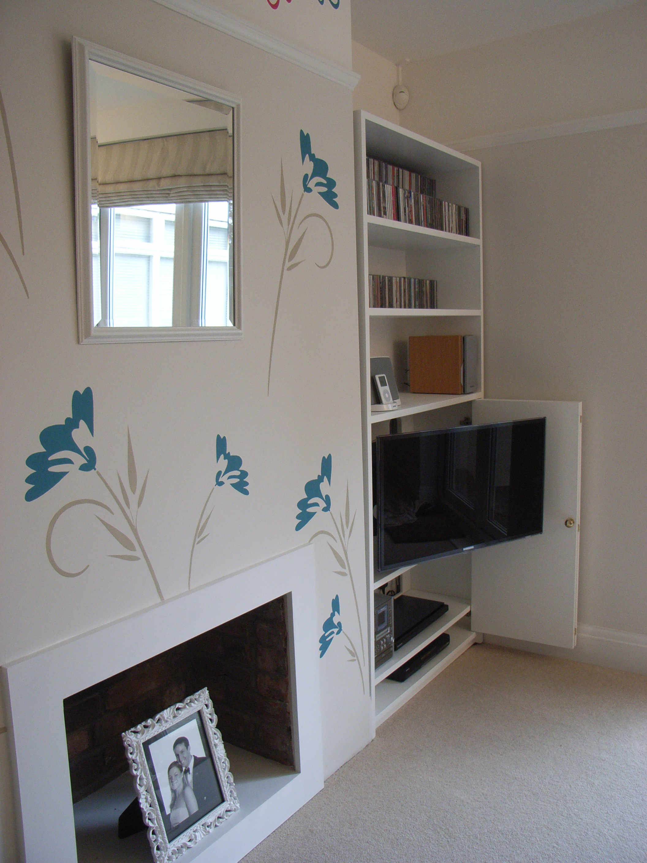 stencilled wall and TV unit