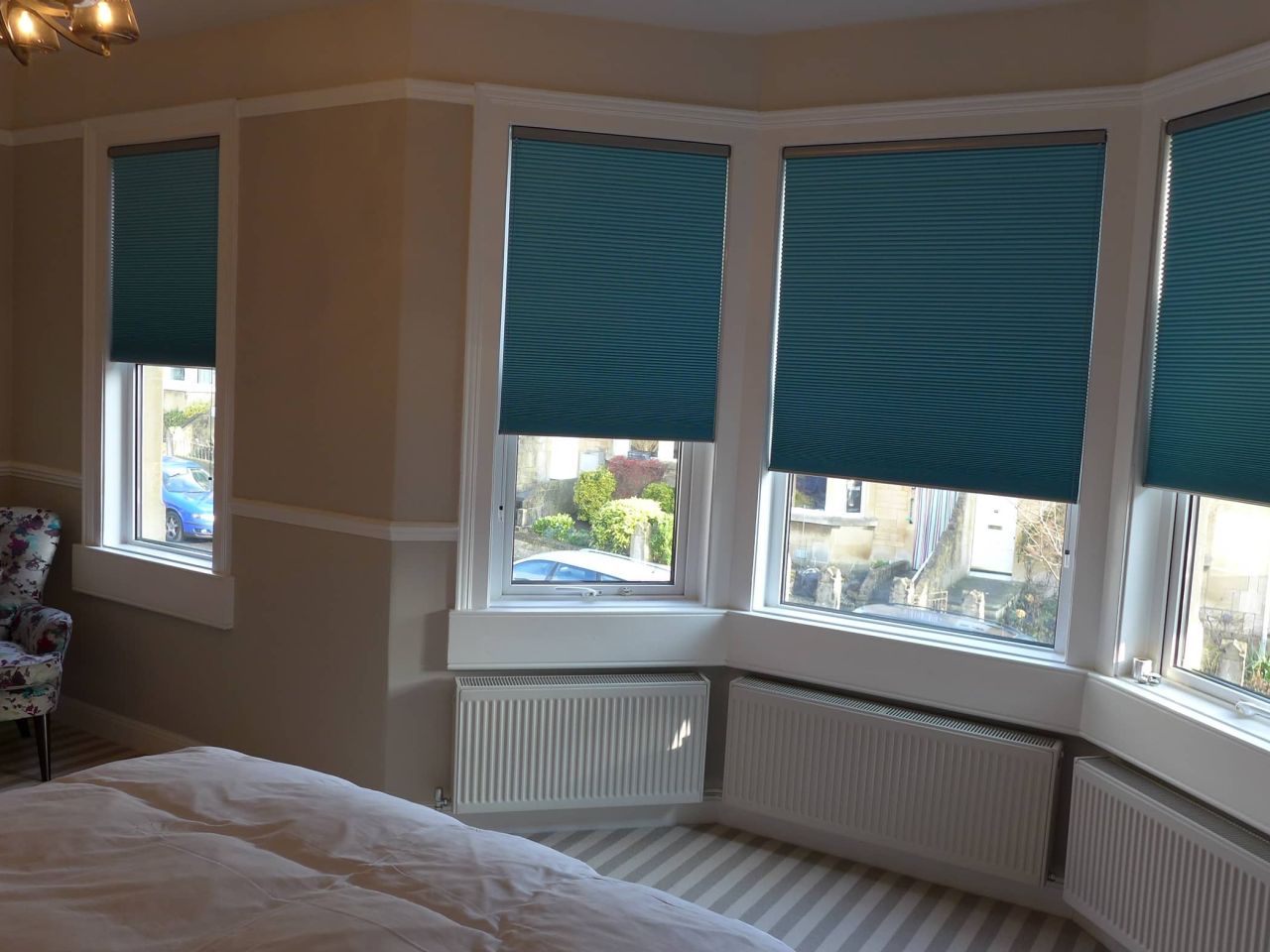 bedroom with teal pleated blinds