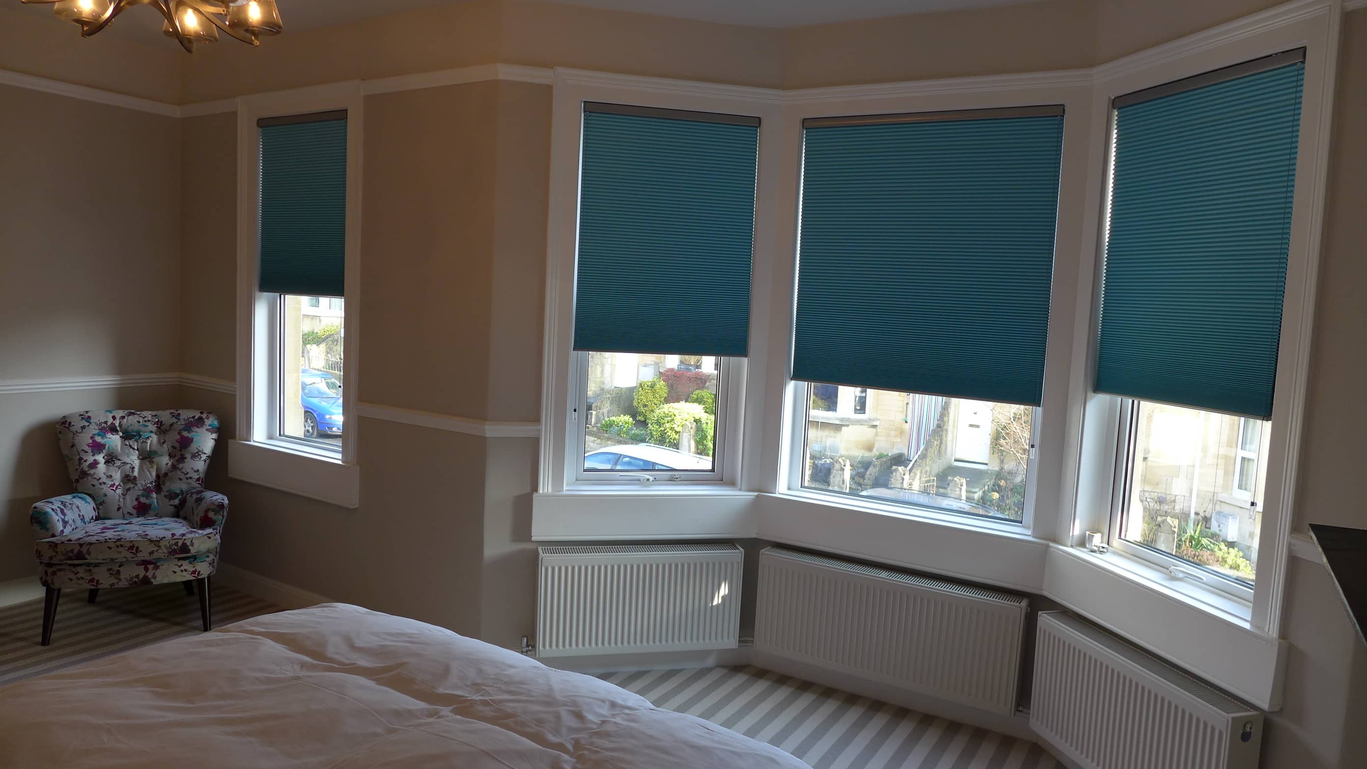 bedroom with teal pleated blinds