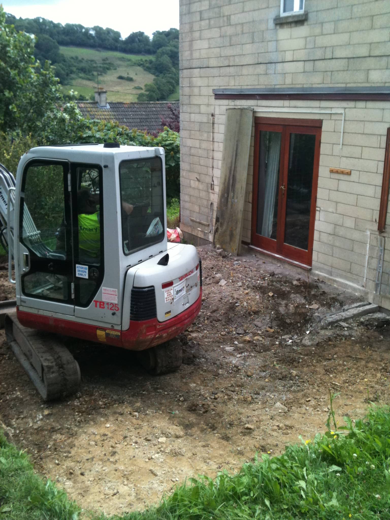 digger demolishes old conservatory