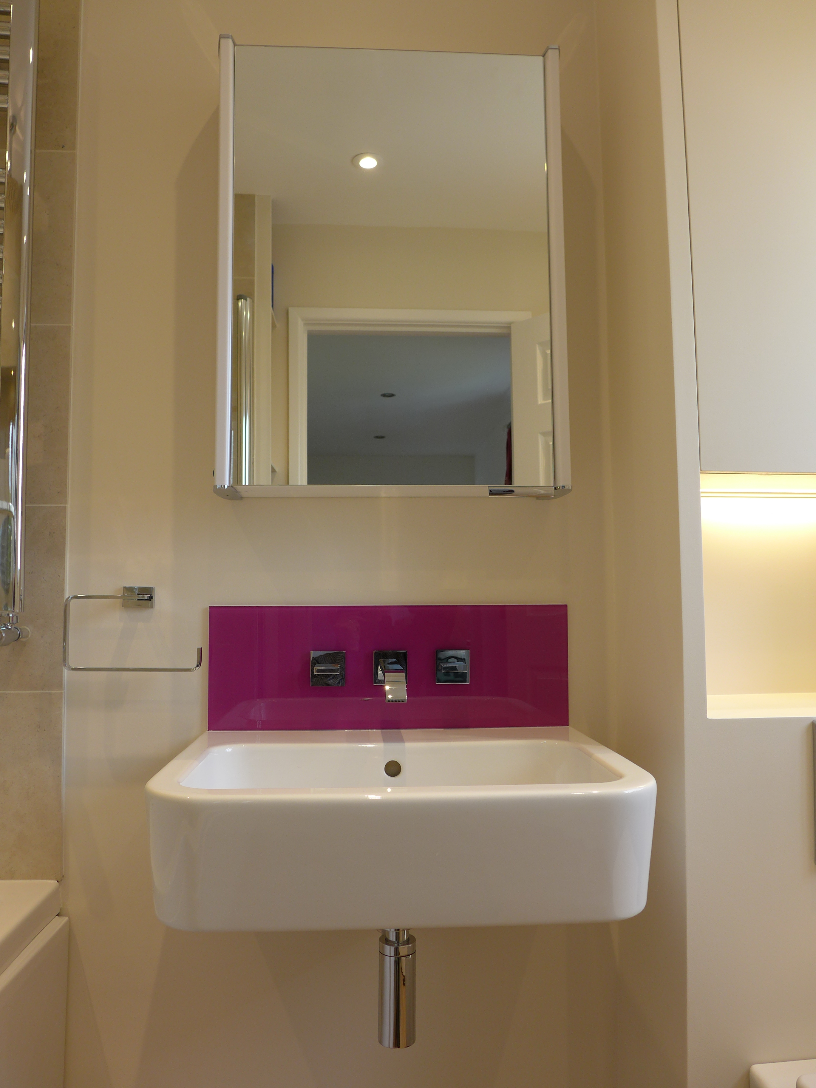 wall hung basin with purple glass splashback