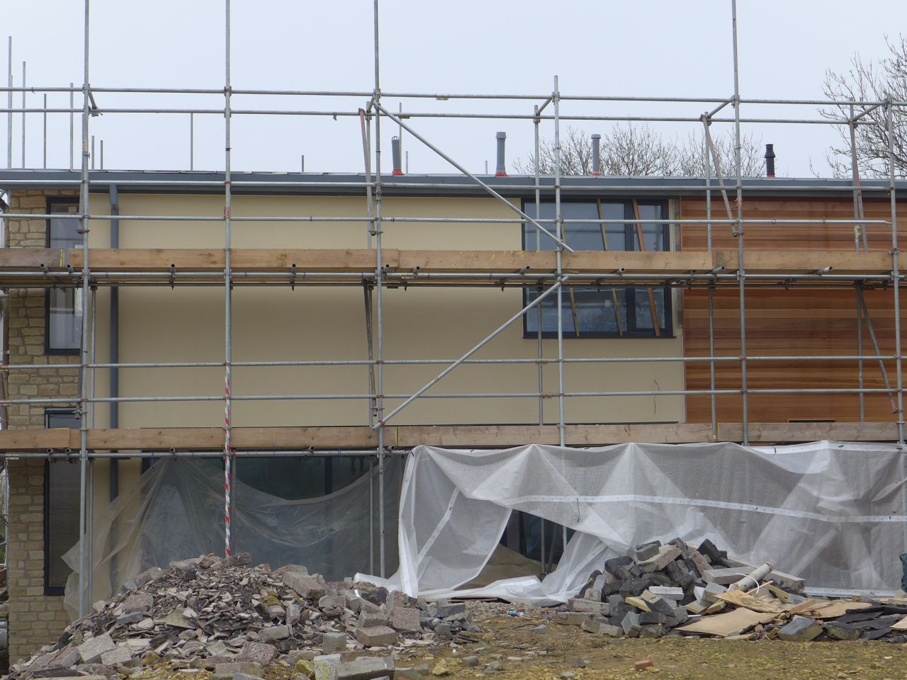 new build with timber cladding and rough stone