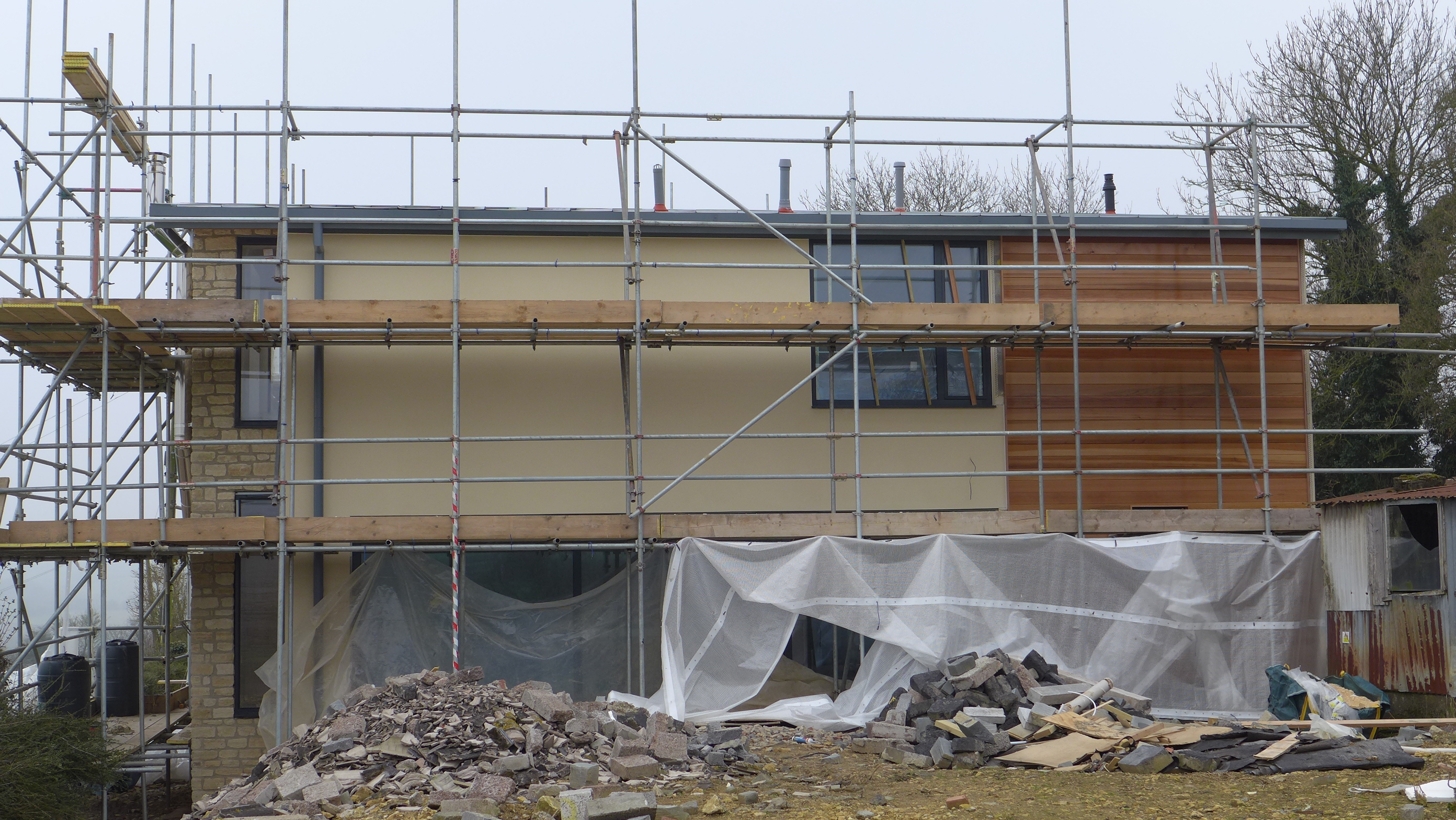 new build with timber cladding and rough stone