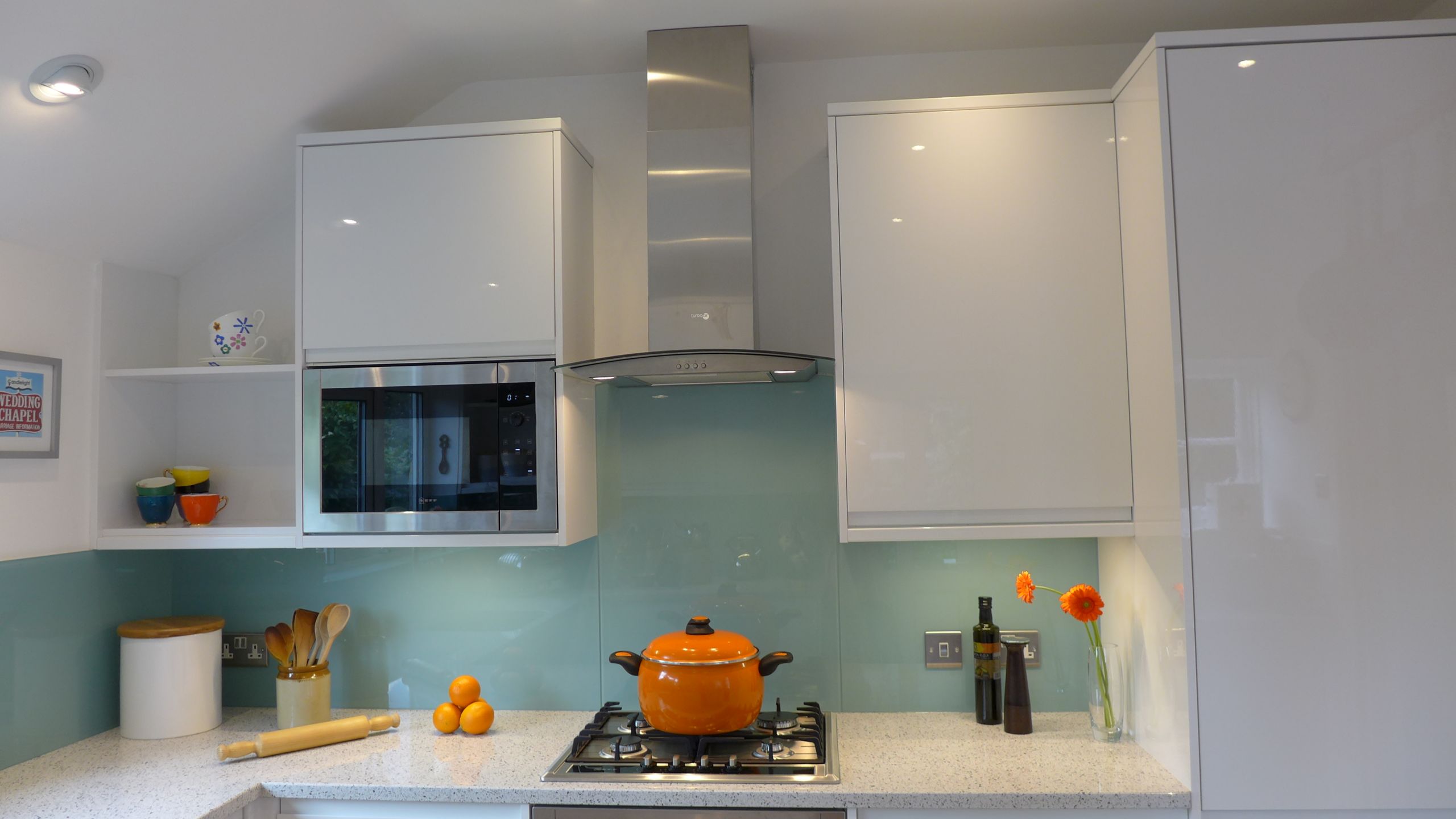 modern kitchen with ice blue glass splashback