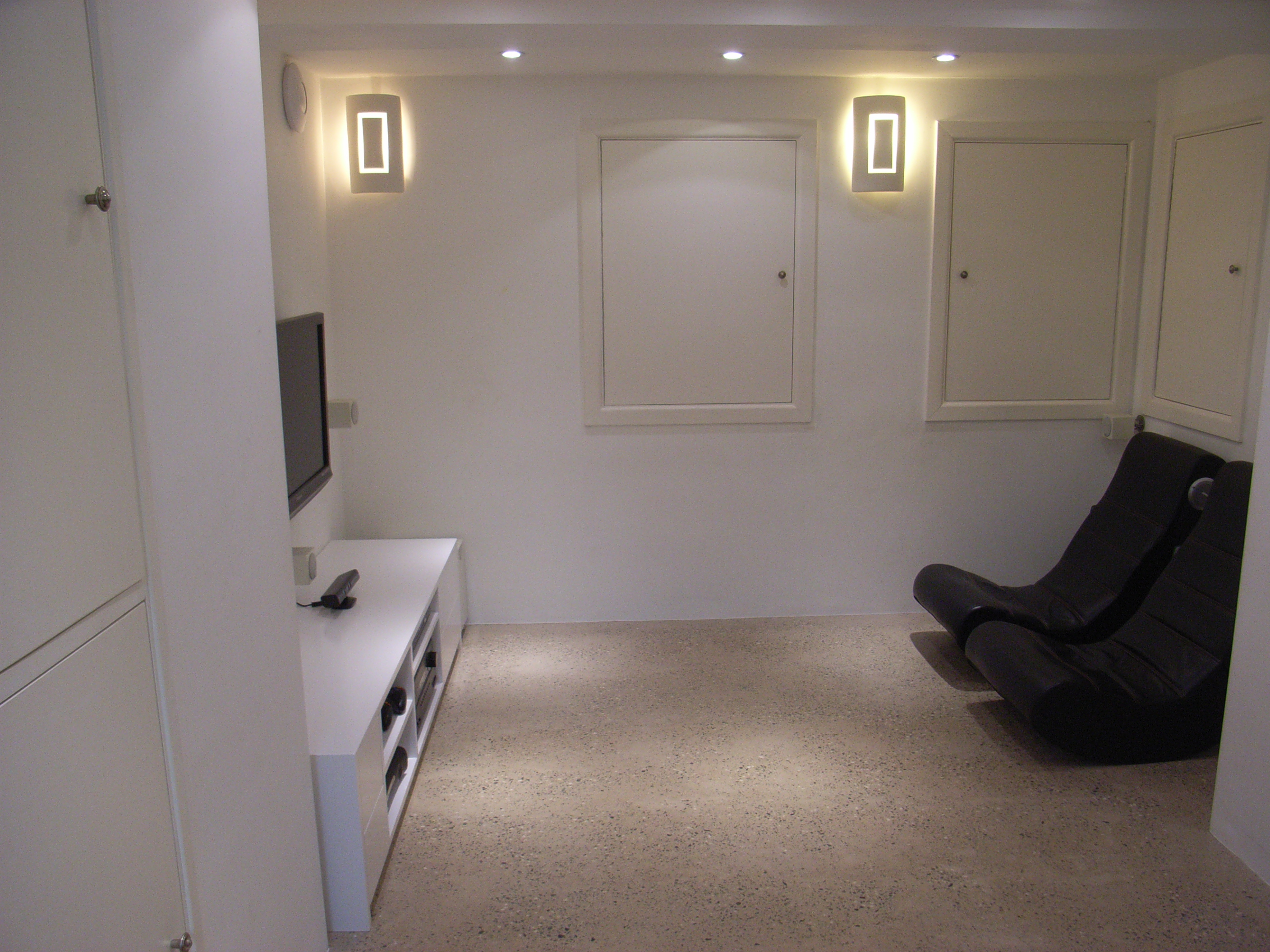 this basement conversion is used as a small home cinema and laundry