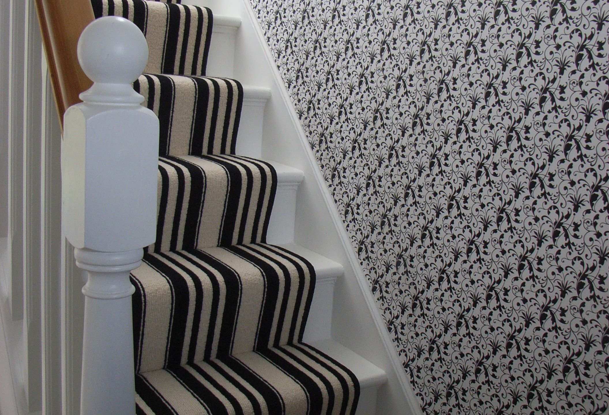 a selection of deoration ideas for halls, stairs and landings, including this black and white scheme