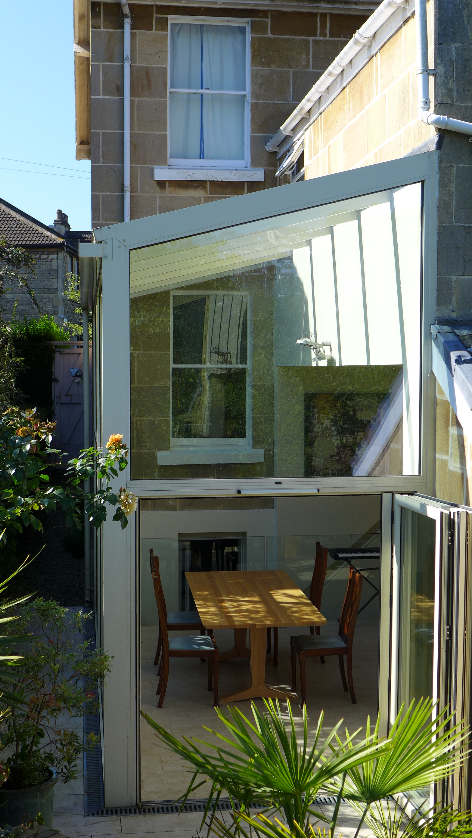 open plan kitchen diner in glass conservatory