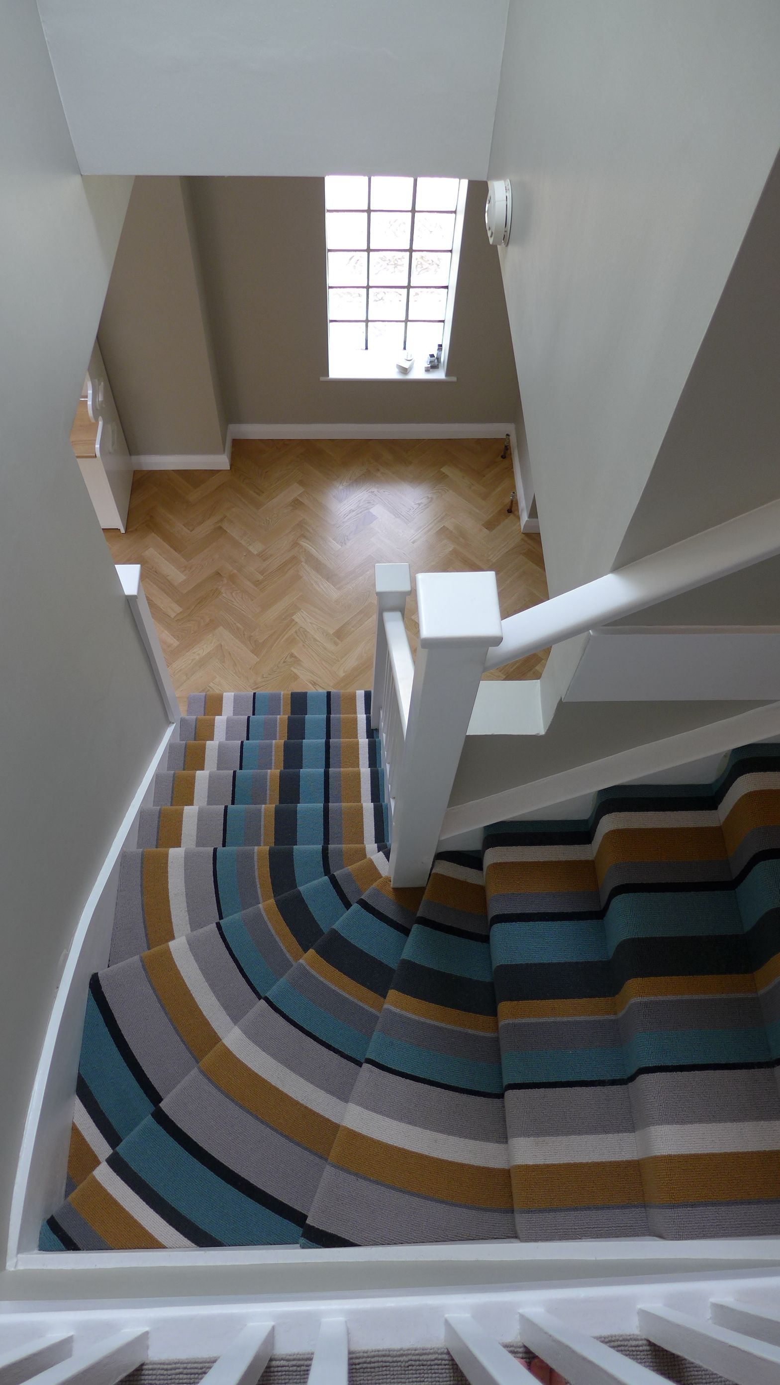 striped stair carpet to parquet hall floor
